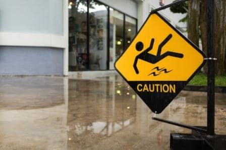 caution sign over wet floor in office building foyer